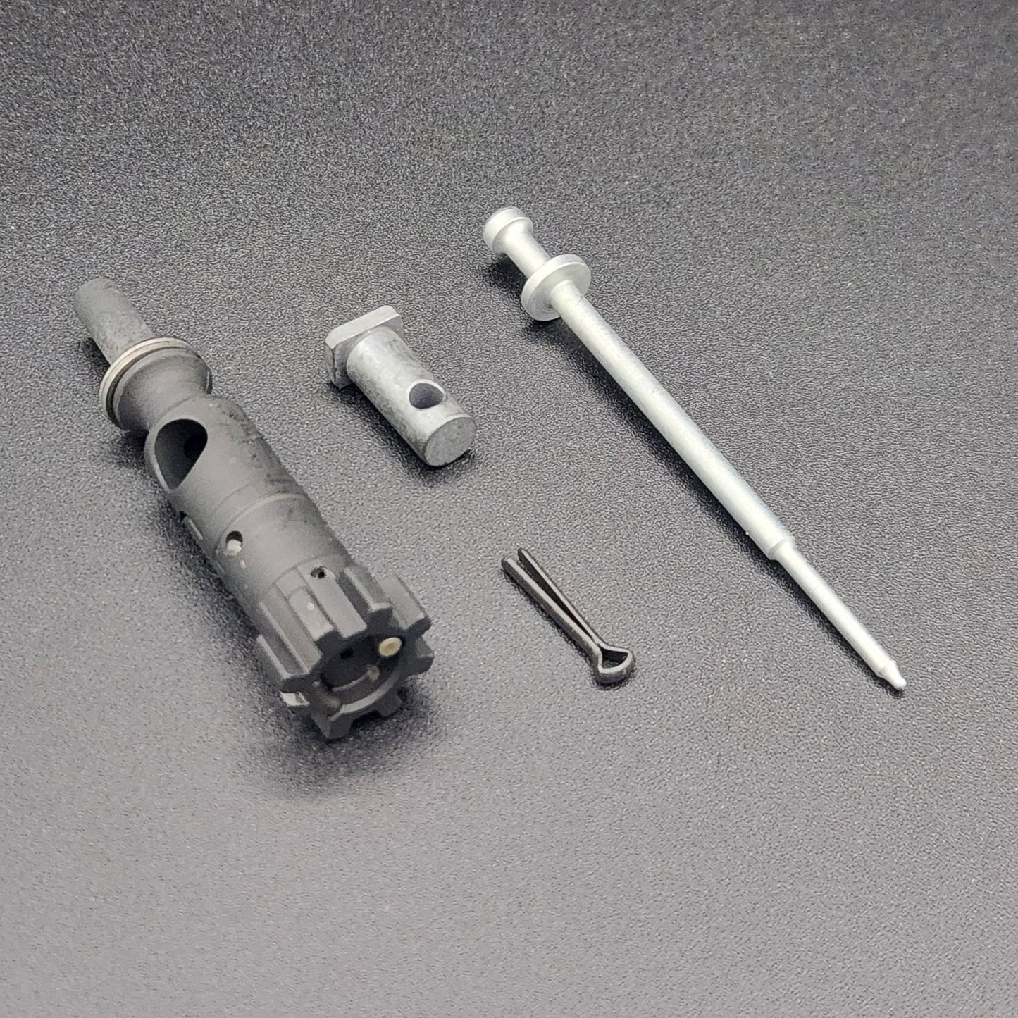 AR-15 bolt parts on a black background