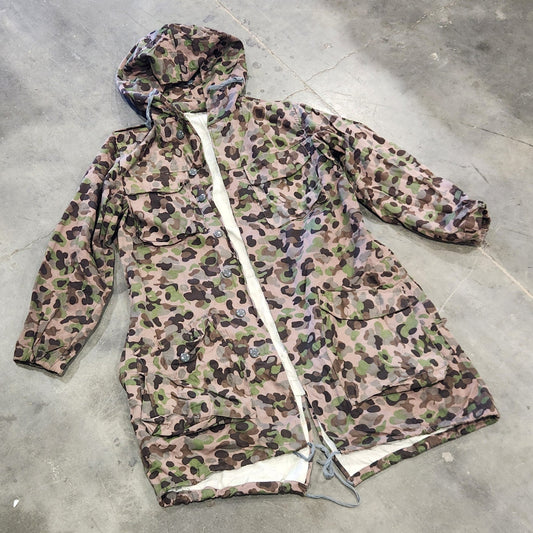 Leopard print jacket on a concrete floor with scattered papers.