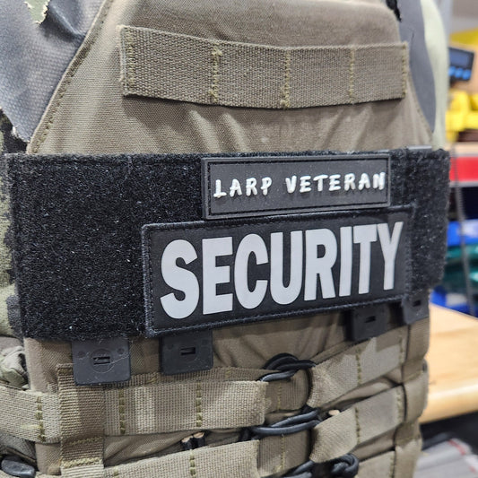 Security vest with 'LARP VETERAN' and 'SECURITY' patches on a person wearing it.