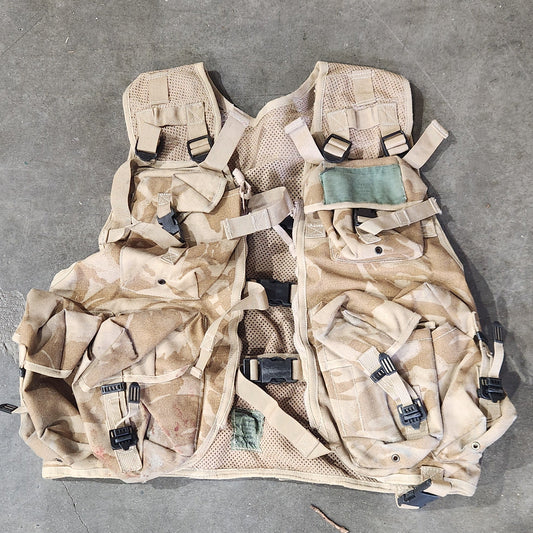 Camouflage tactical vest on a concrete floor