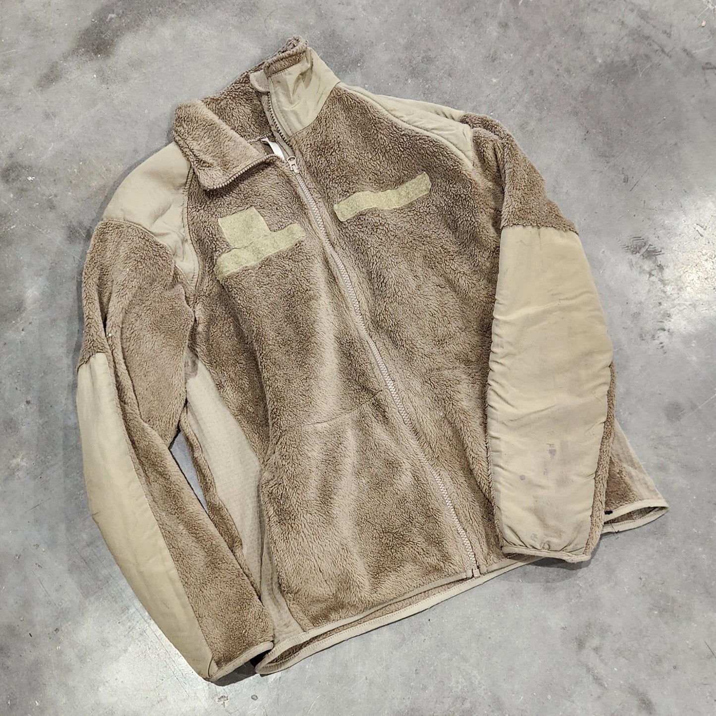 Brown jacket on a gray concrete floor
