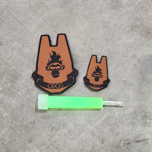 Small brown figurines and a green tube on a gray concrete surface