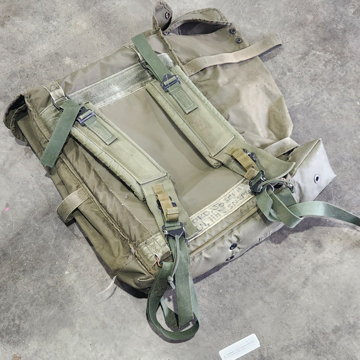 Green backpack on a concrete surface