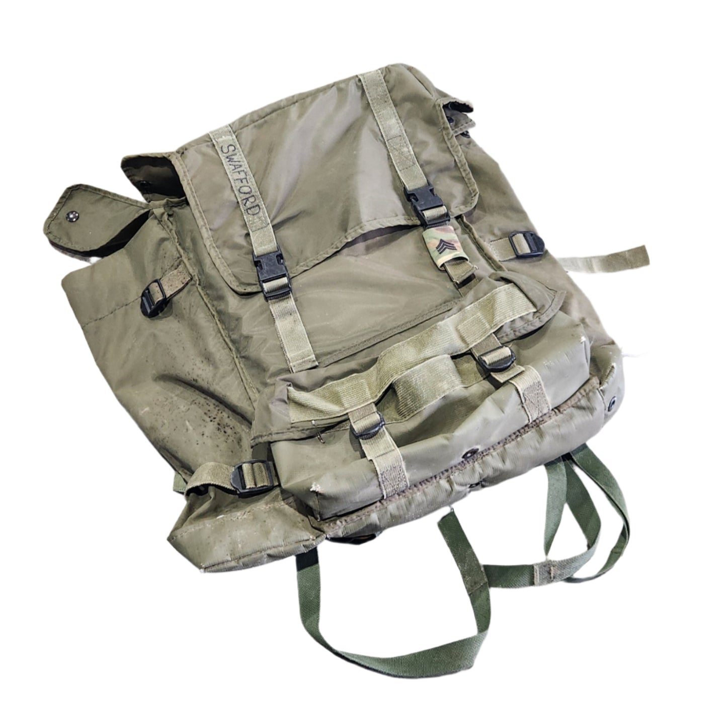 Green backpack on a gray concrete floor