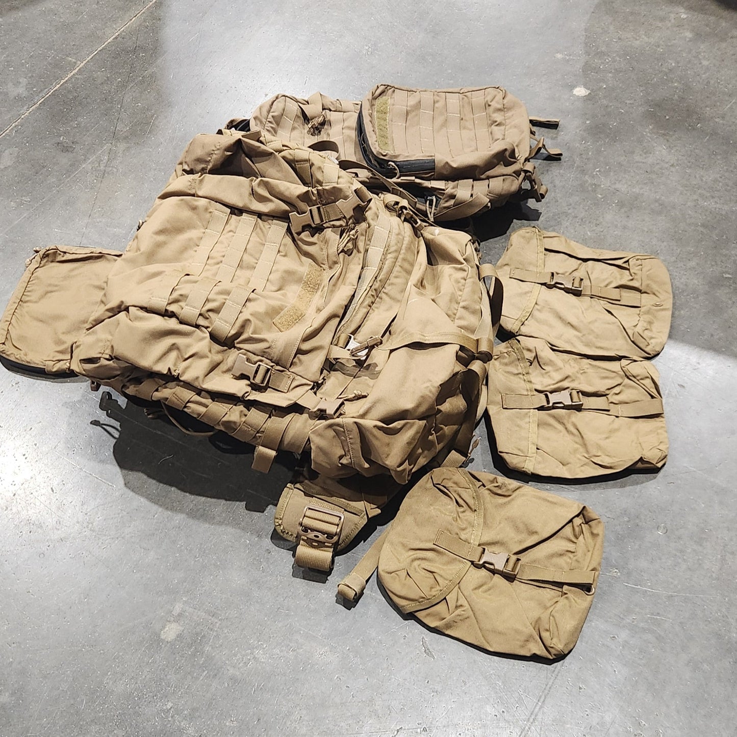 Tan tactical vest on a concrete floor