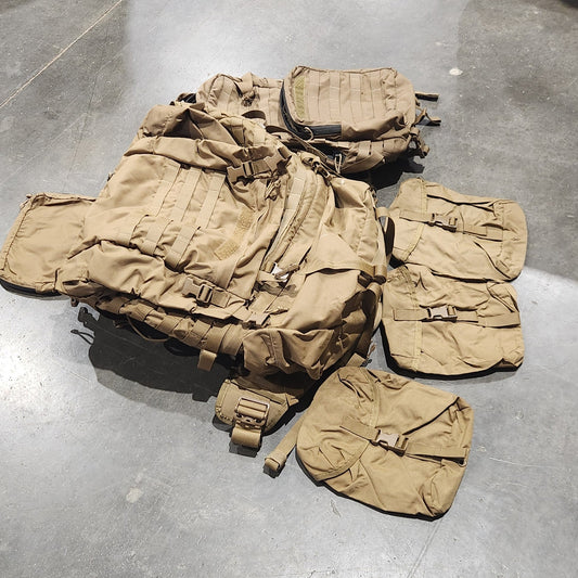 Tan tactical vest on a concrete floor