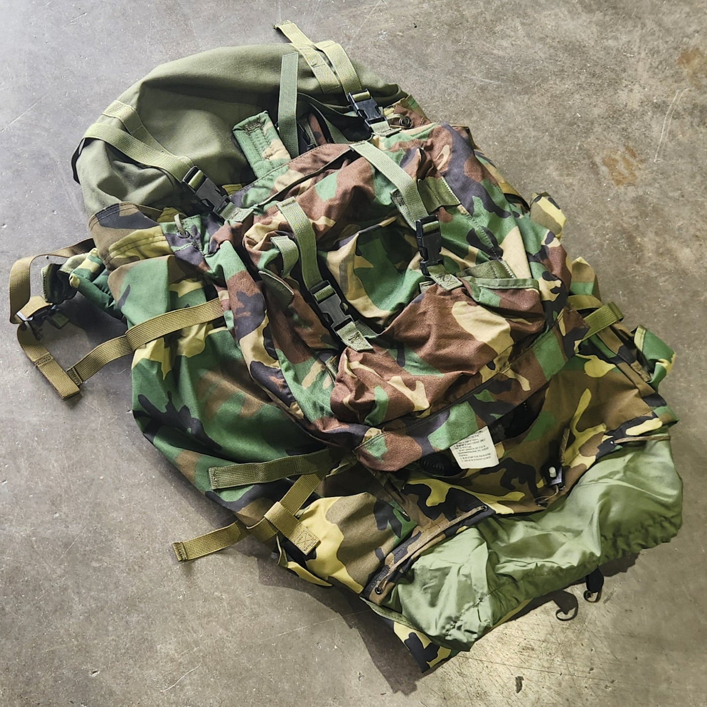 Camouflage fabric and pouches on a concrete surface