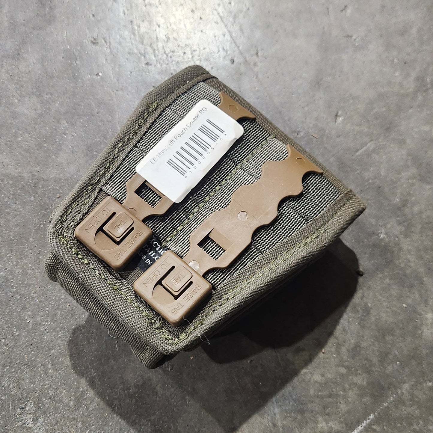 Small rectangular object with a label on a gray surface