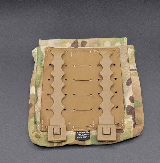 Camouflage tactical magazine pouch with a tan interior panel on a gray background