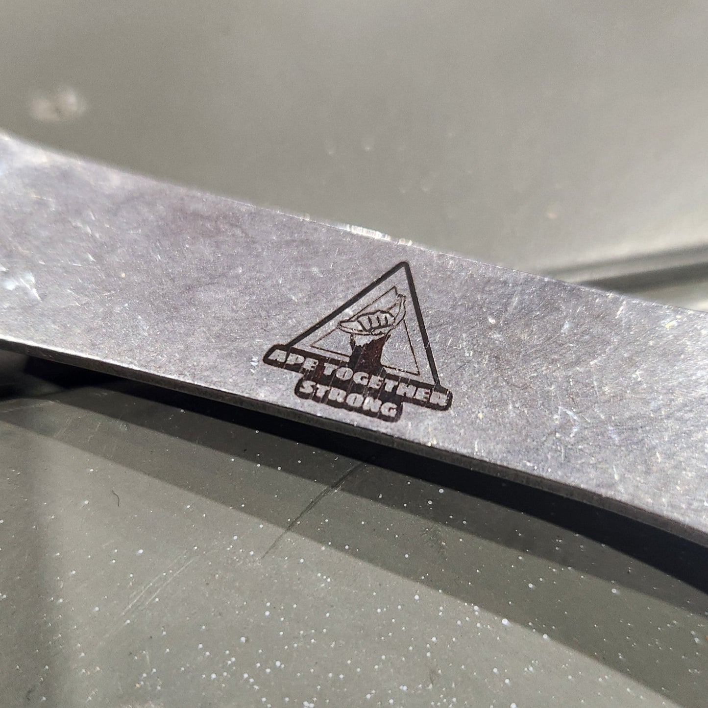 Close-up of a car door with a warning triangle symbol on a metallic surface.