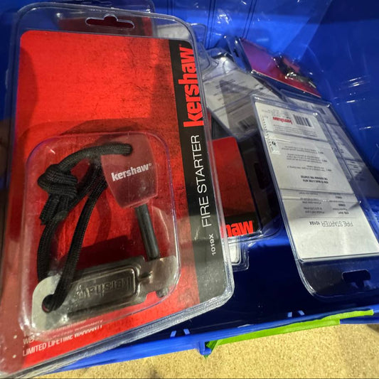 Kershaw fire starter in packaging on a blue surface