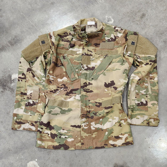 Aircrew OCP Camouflage jacket with various patches on a gray surface