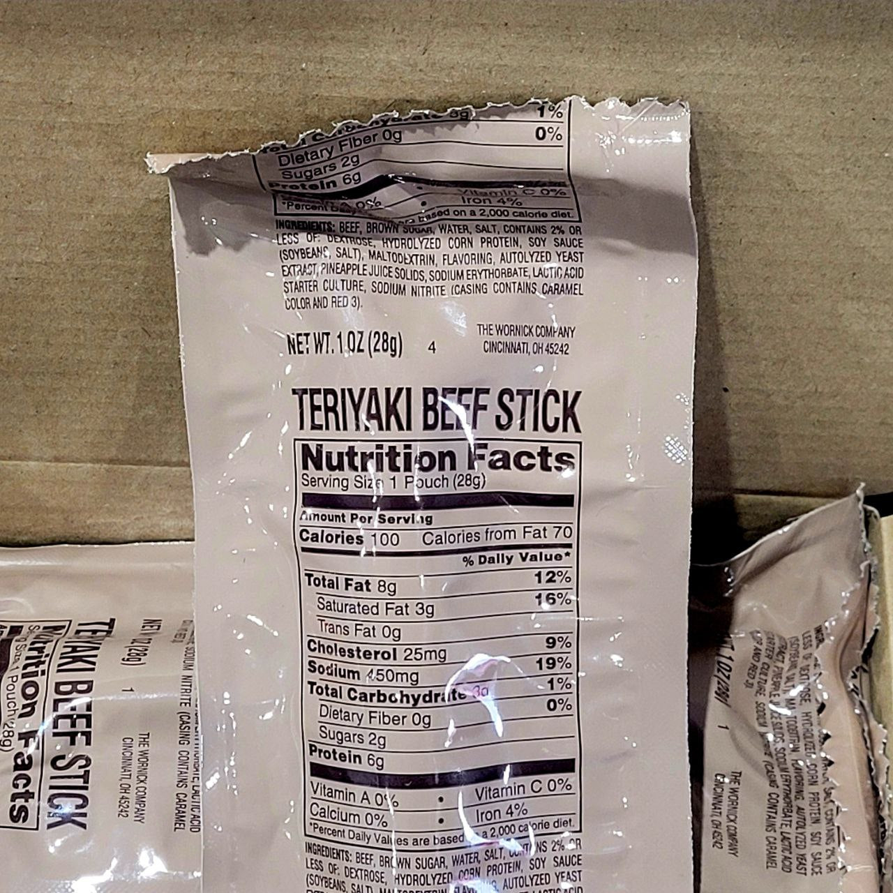 Teriyaki beef stick packaging with nutrition facts label on a cardboard background