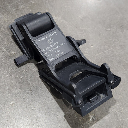 Black plastic component on a gray concrete floor