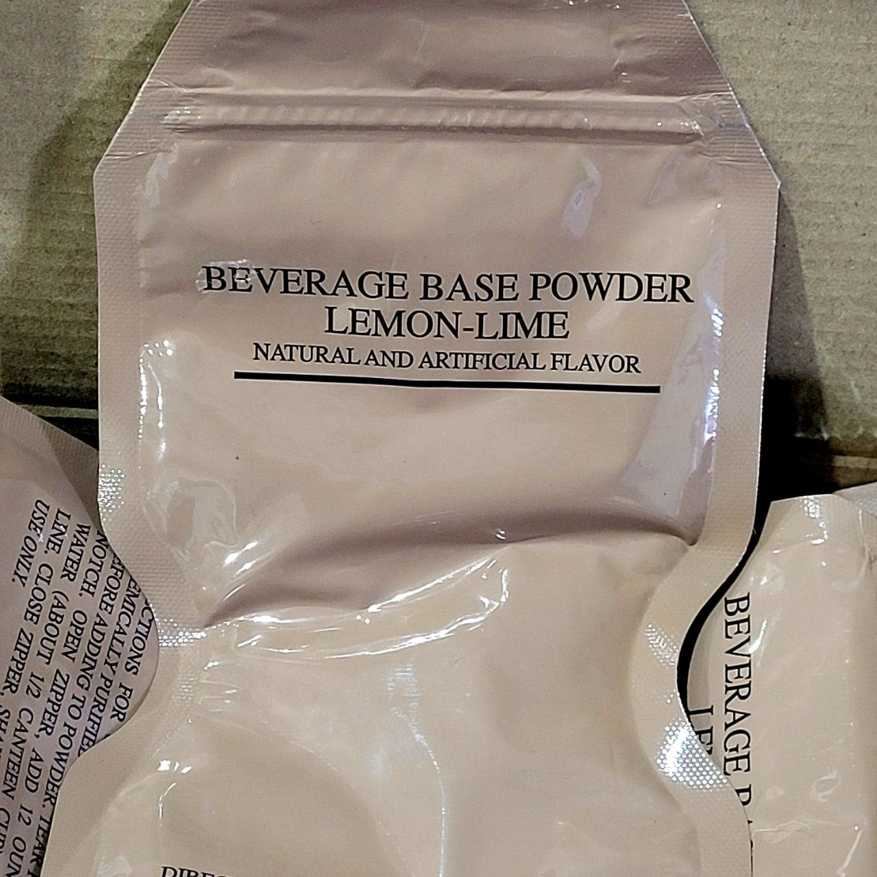 Beverage base powder packet labeled 'Lemon-Lime' on a textured surface.
