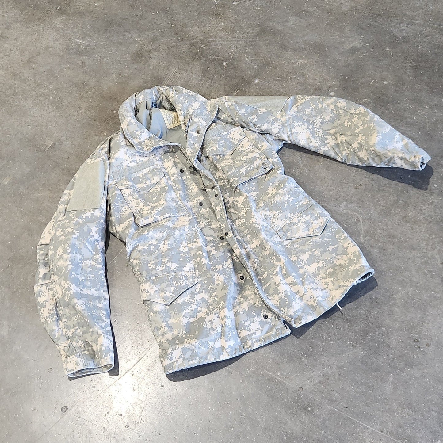 UCP M65 Jacket on a concrete floor