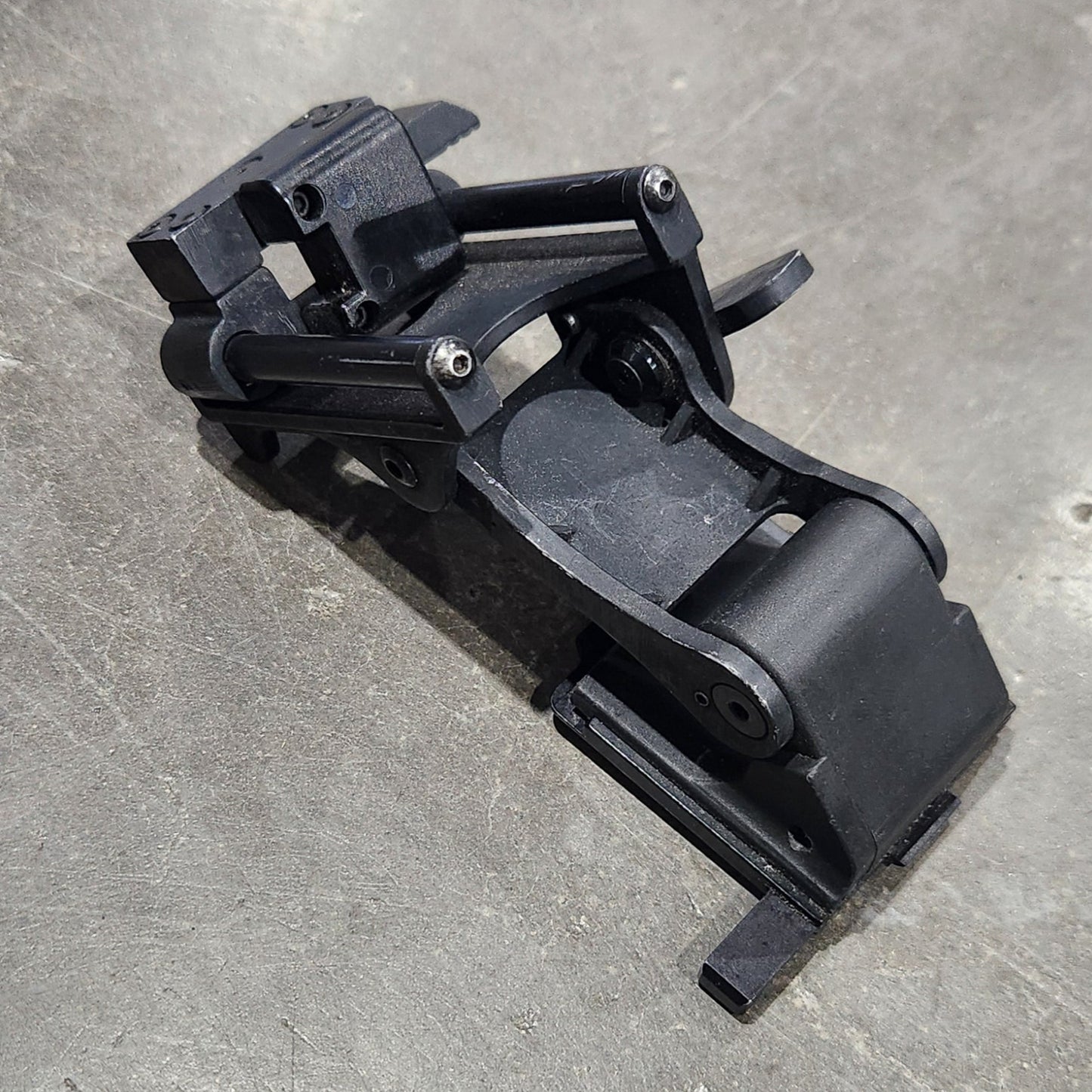 Black metal bracket on a gray concrete surface