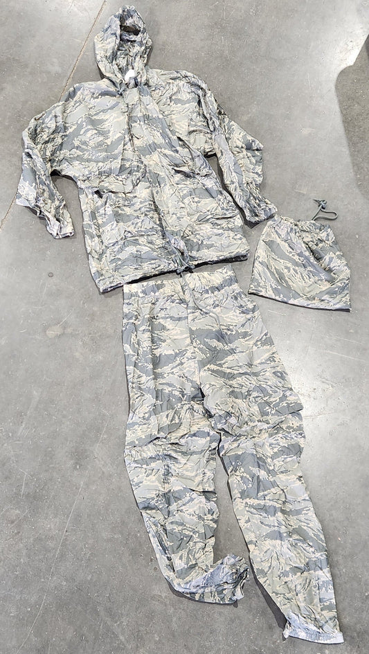 Camouflage military uniform on a concrete floor