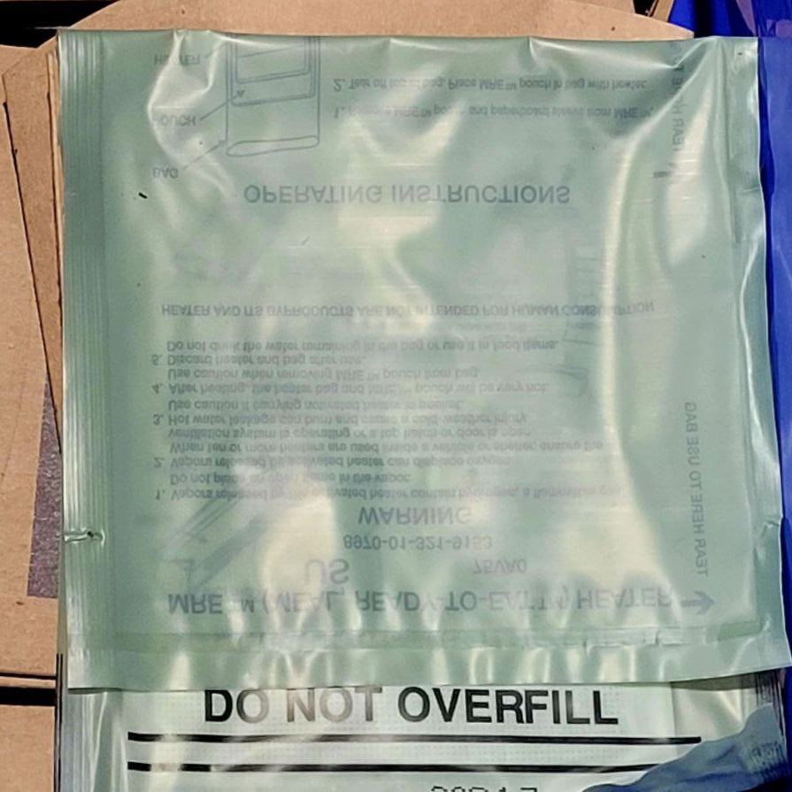 Cardboard box with a plastic bag labeled 'Do Not Overfill' on a blue surface.