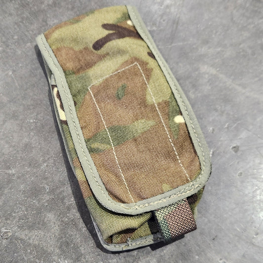 Multicam-patterned pouch on a gray surface