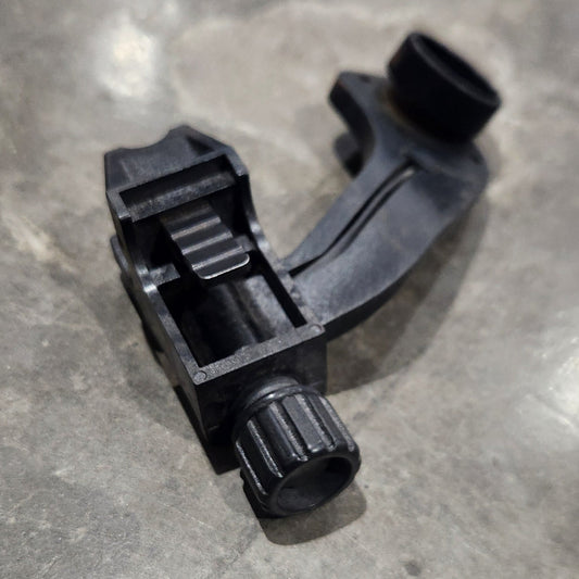 Black plastic component on a gray concrete surface