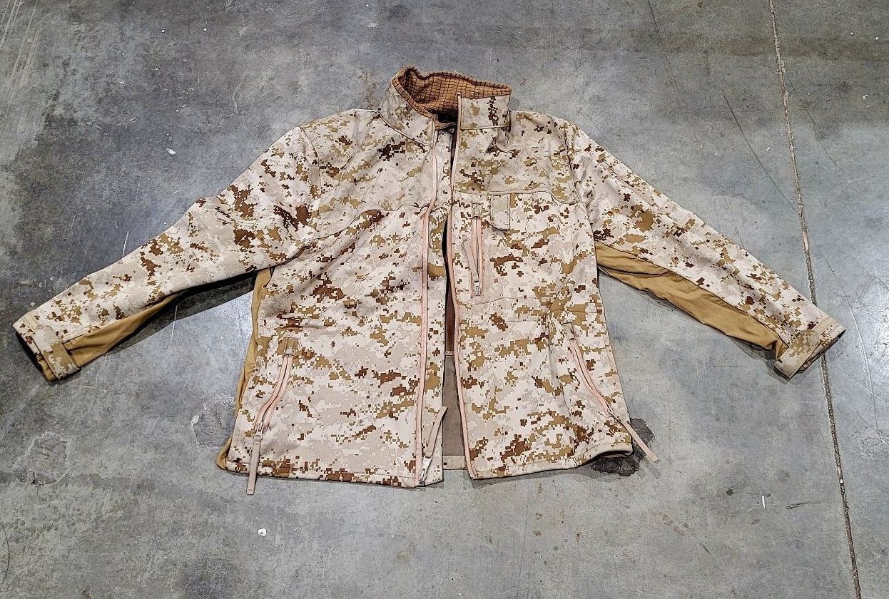 Camouflage jacket on a gray concrete floor