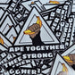 Stack of 'Ape Together Strong' stickers with graphic design on a wooden surface