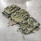 Camouflage backpacks on a concrete floor