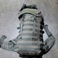 Tactical backpack on a gray concrete floor