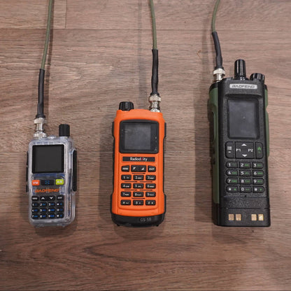 Three handheld radios on a wooden surface