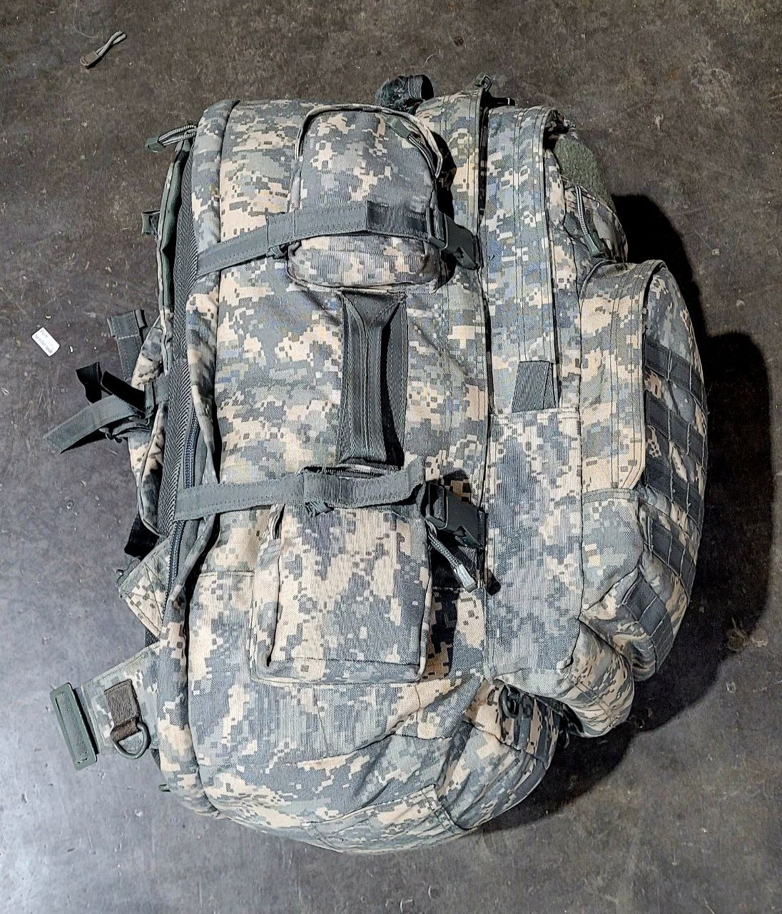 Camouflage backpack on a dark surface