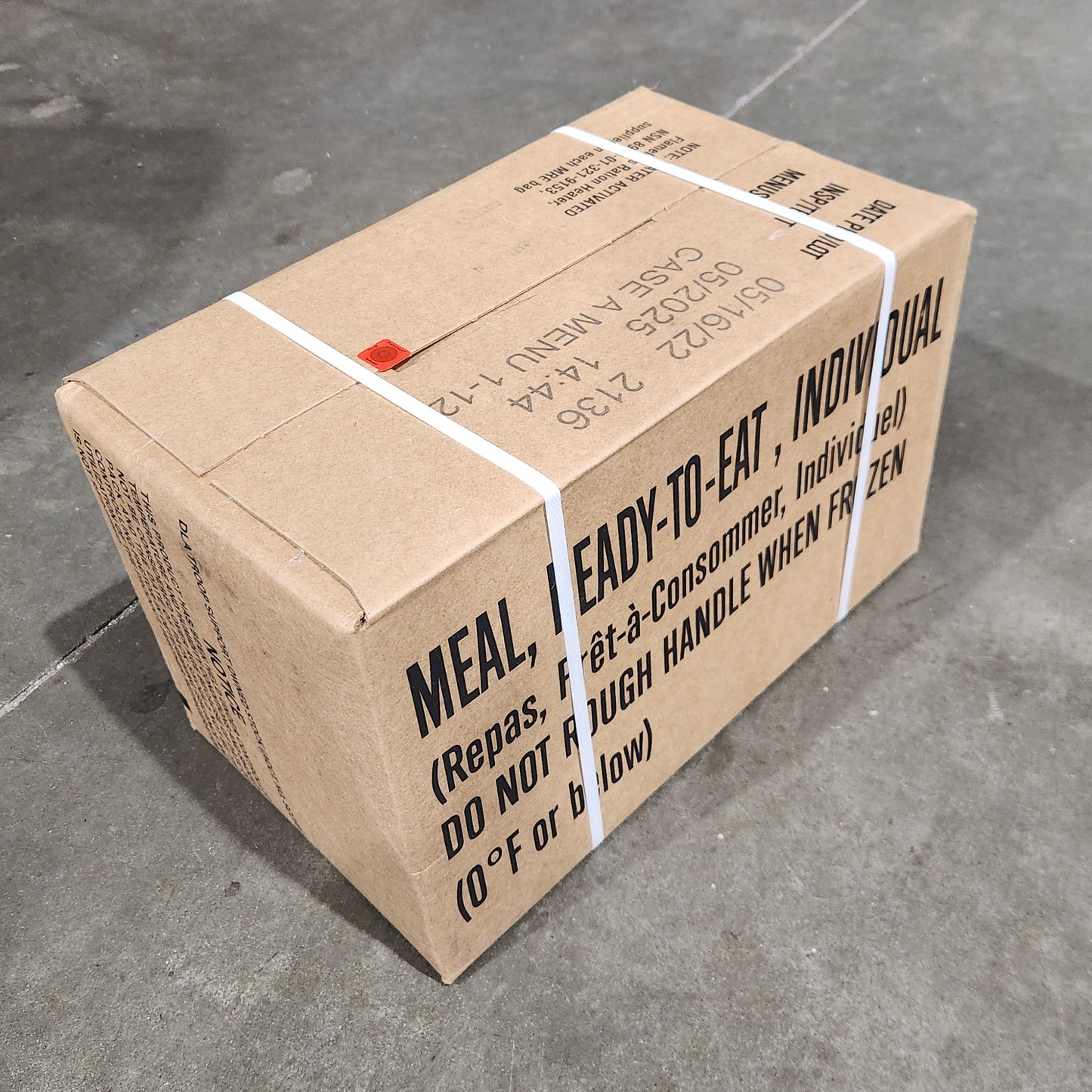 Cardboard box with text on a concrete floor