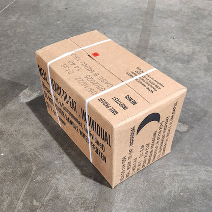 Cardboard box with shipping labels on a concrete floor