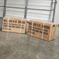 Two cardboard boxes on a metal pallet with a concrete floor in the background.