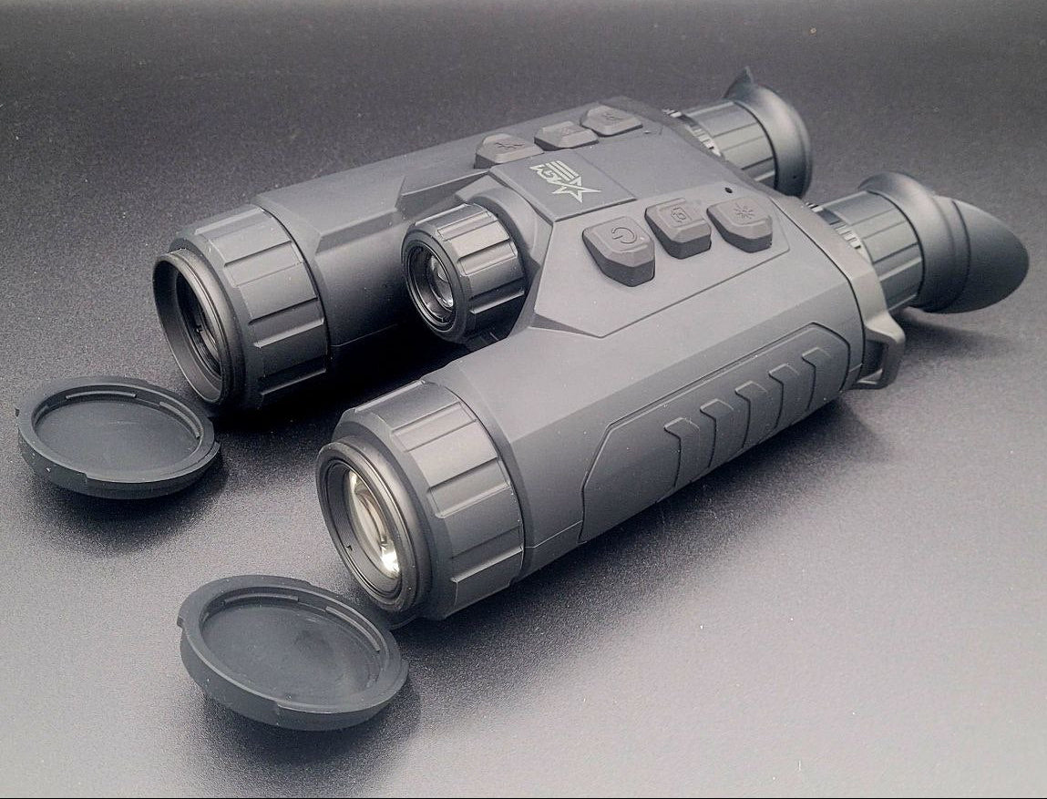 Two gray thermal imaging devices on a dark surface