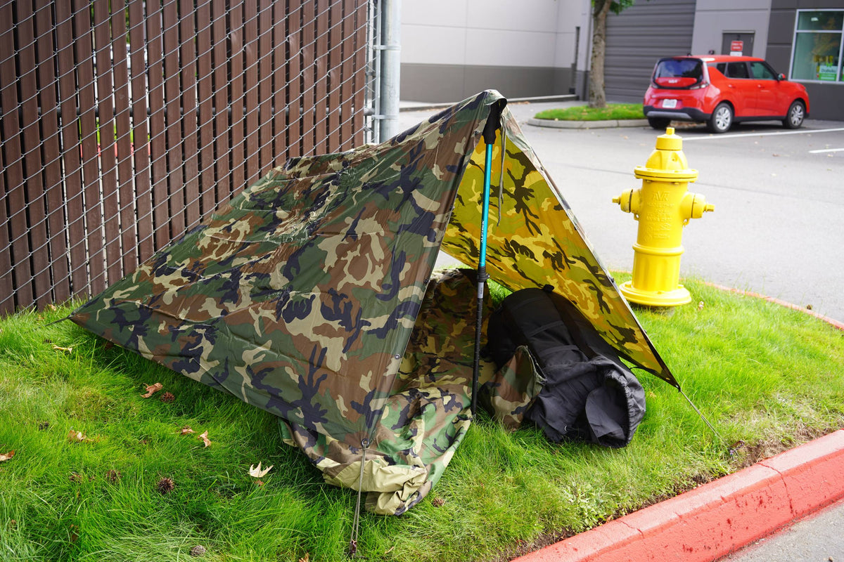 how a poncho can work as an improvised homeless shelter