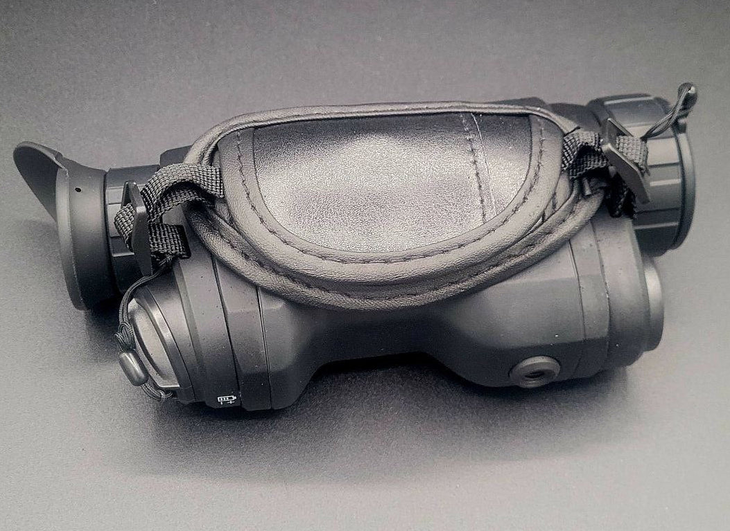 Black night vision goggles on a gray background