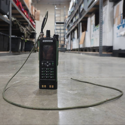Walkie-talkie on a warehouse floor with shelves and boxes in the background
