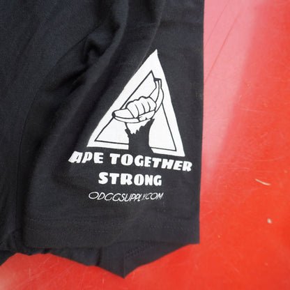 Black t-shirt with a white logo on a red surface