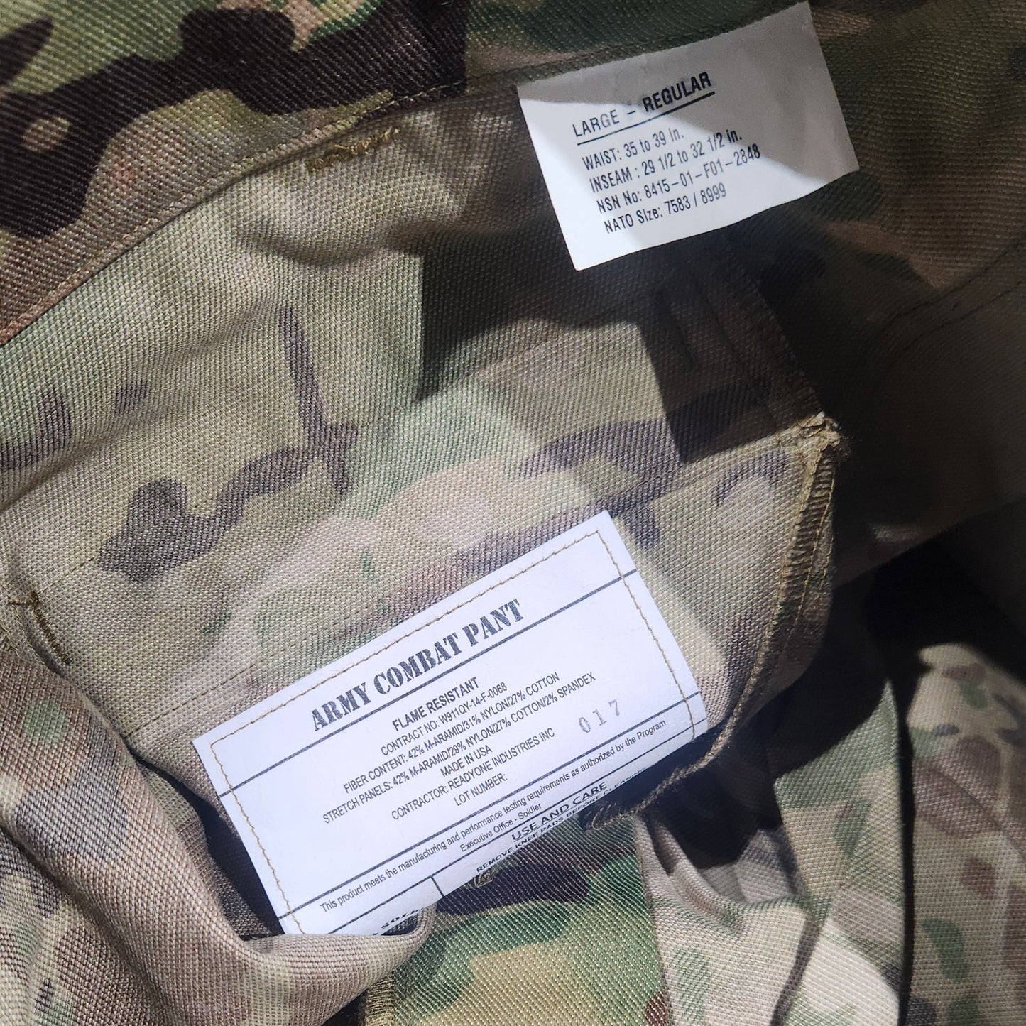 Camouflage military uniform with labels on a dark background