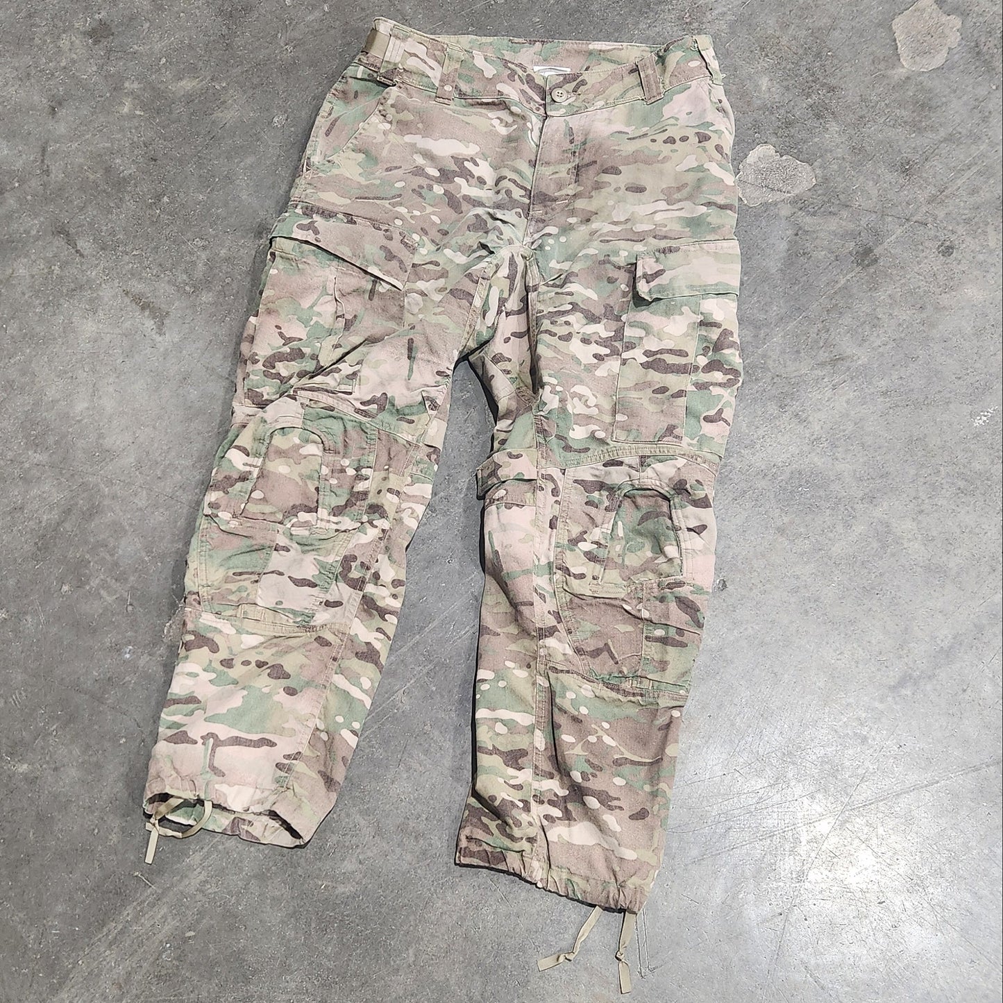Multicam patterned pants on a concrete floor