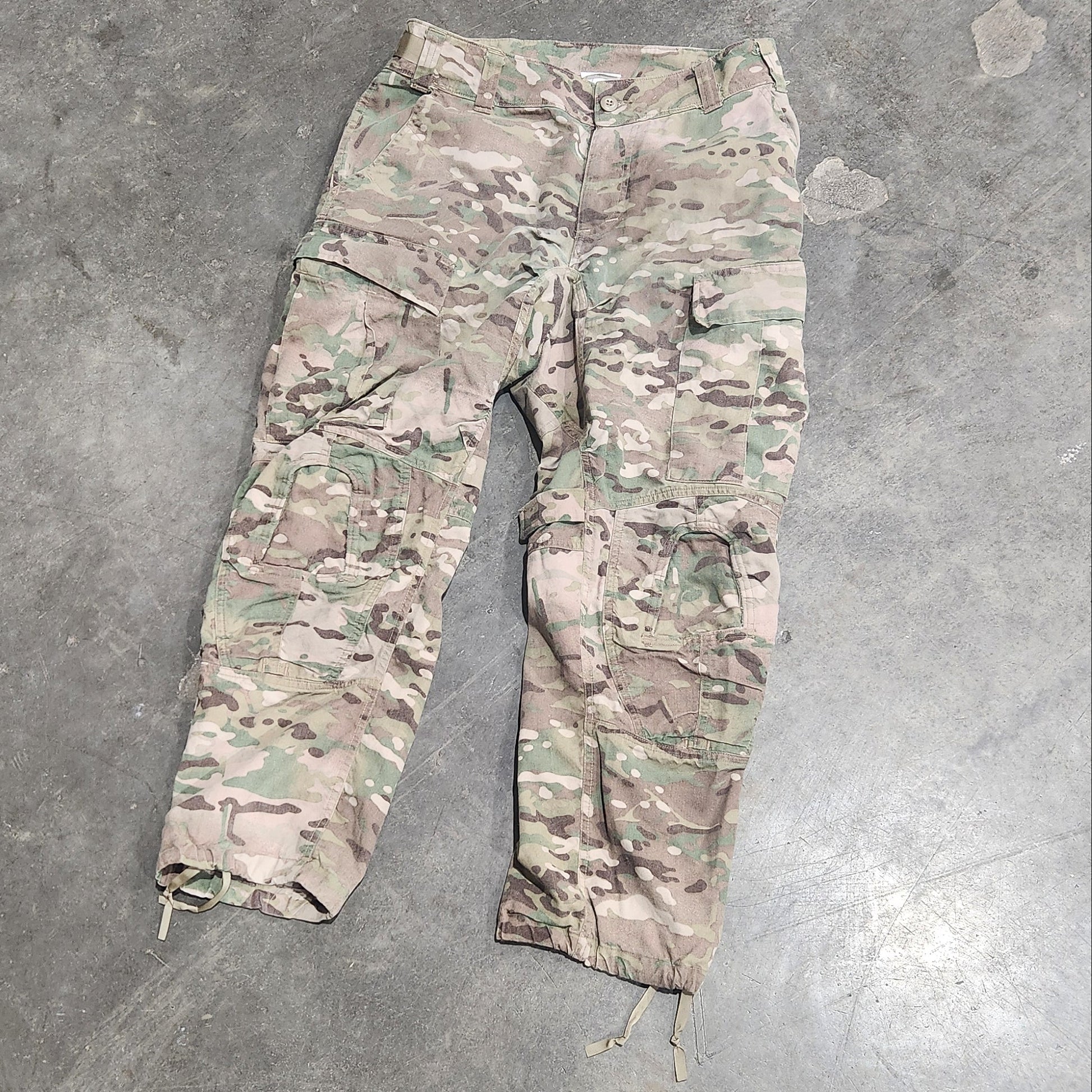 Multicam patterned pants on a concrete floor