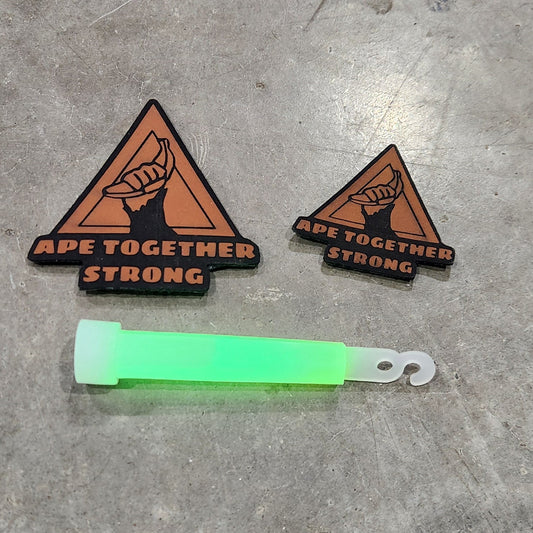 Two triangular patches with text and a green highlighter on a gray concrete surface