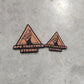 Two triangular stickers on a concrete surface