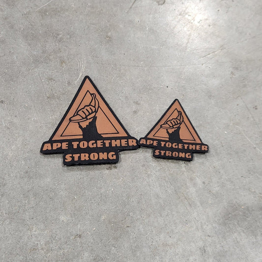 Two triangular stickers on a concrete surface