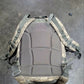 Tactical backpack with camouflage pattern on a gray surface