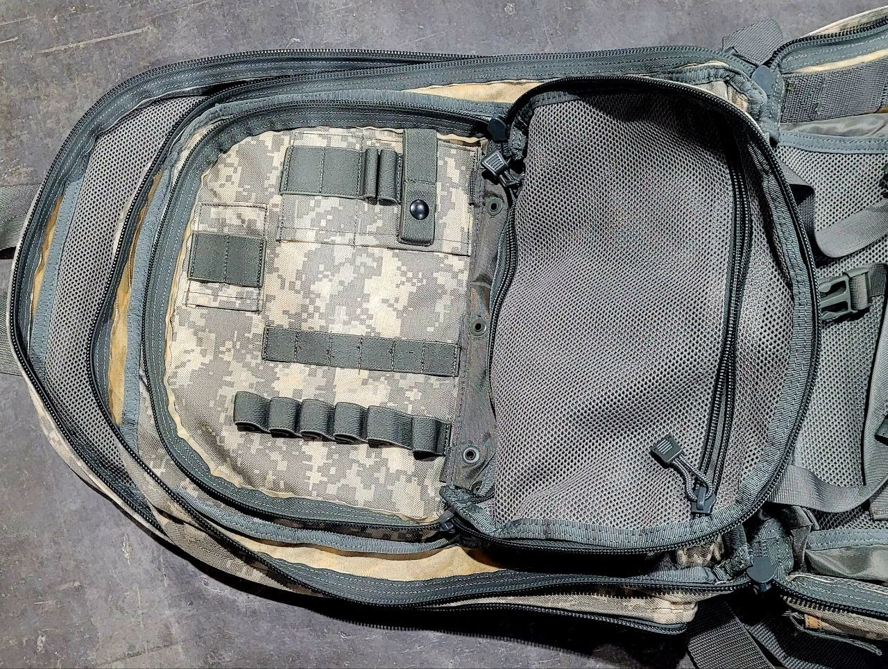 Tactical backpack with ACU camouflage pattern on a gray surface
