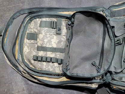Tactical backpack with ACU camouflage pattern on a gray surface