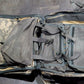 Open tactical backpack with camouflage pattern on a concrete floor