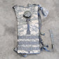 Camouflage-patterned backpack on a gray surface